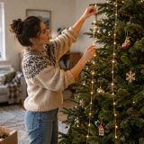 Sapin de Noël décoré avec des guirlandes lumineuses disposées verticalement en colonnes du haut vers le bas, créant un effet lumineux régulier et uniforme sur l'ensemble de l'arbre.